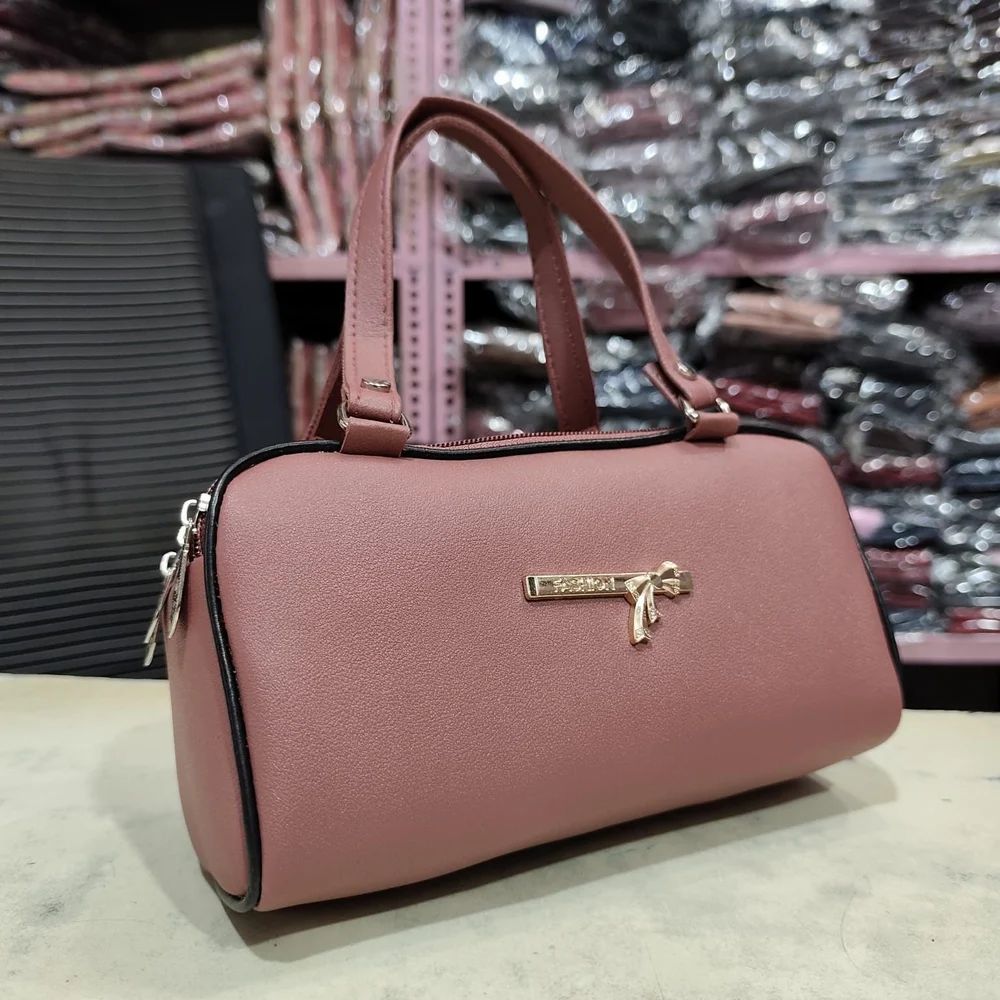 dusty pink leatherette barrel handbag